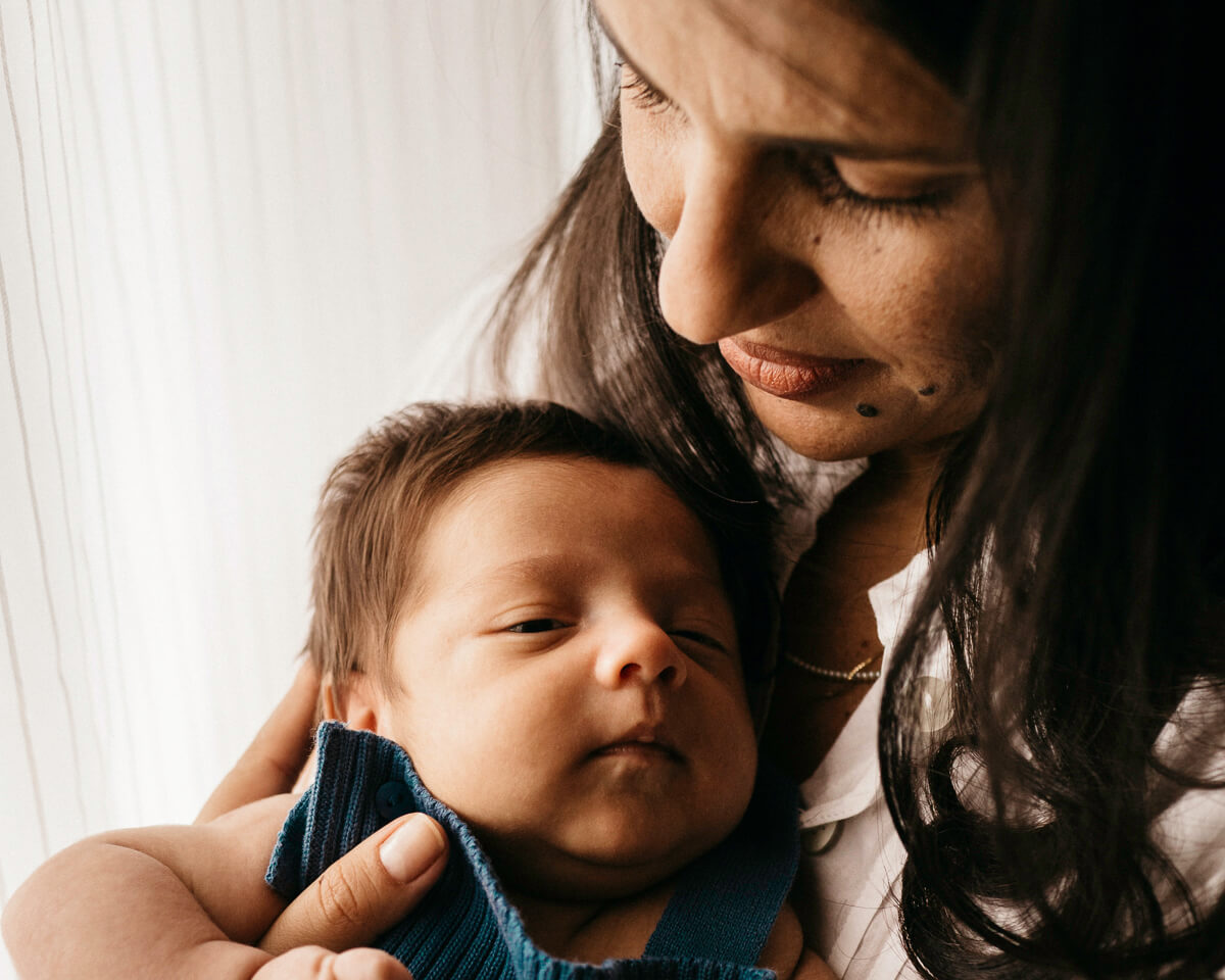 woman holding her baby after receiving care from the hope center